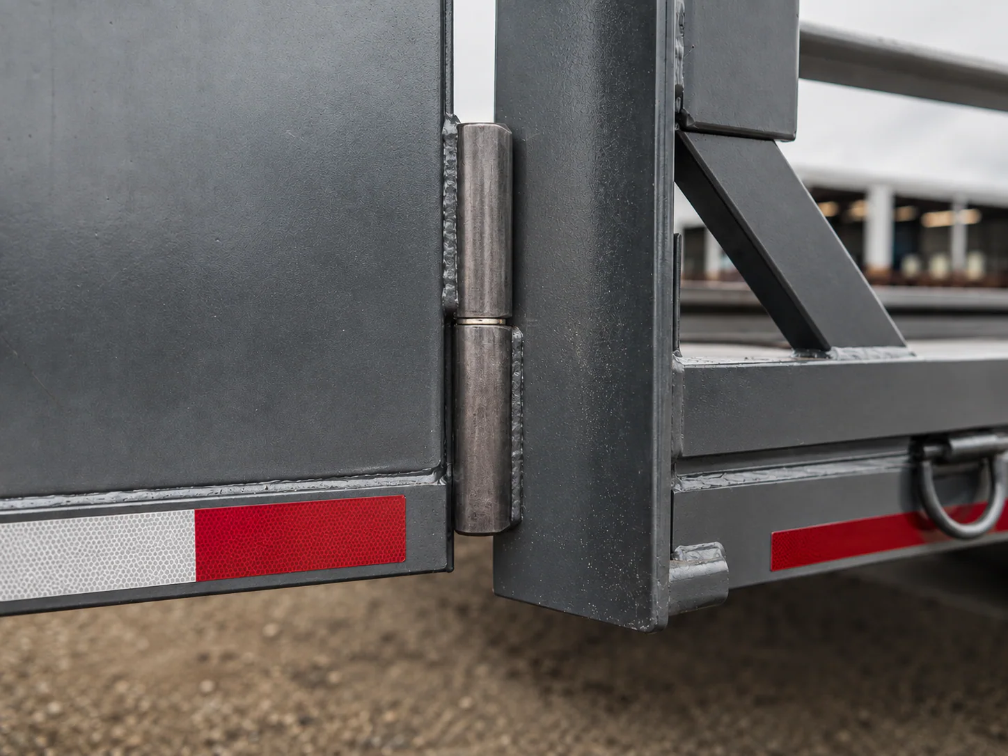 Industrial application illustration showing a weld-on hinge connection on a fabricated gate or trailer structure