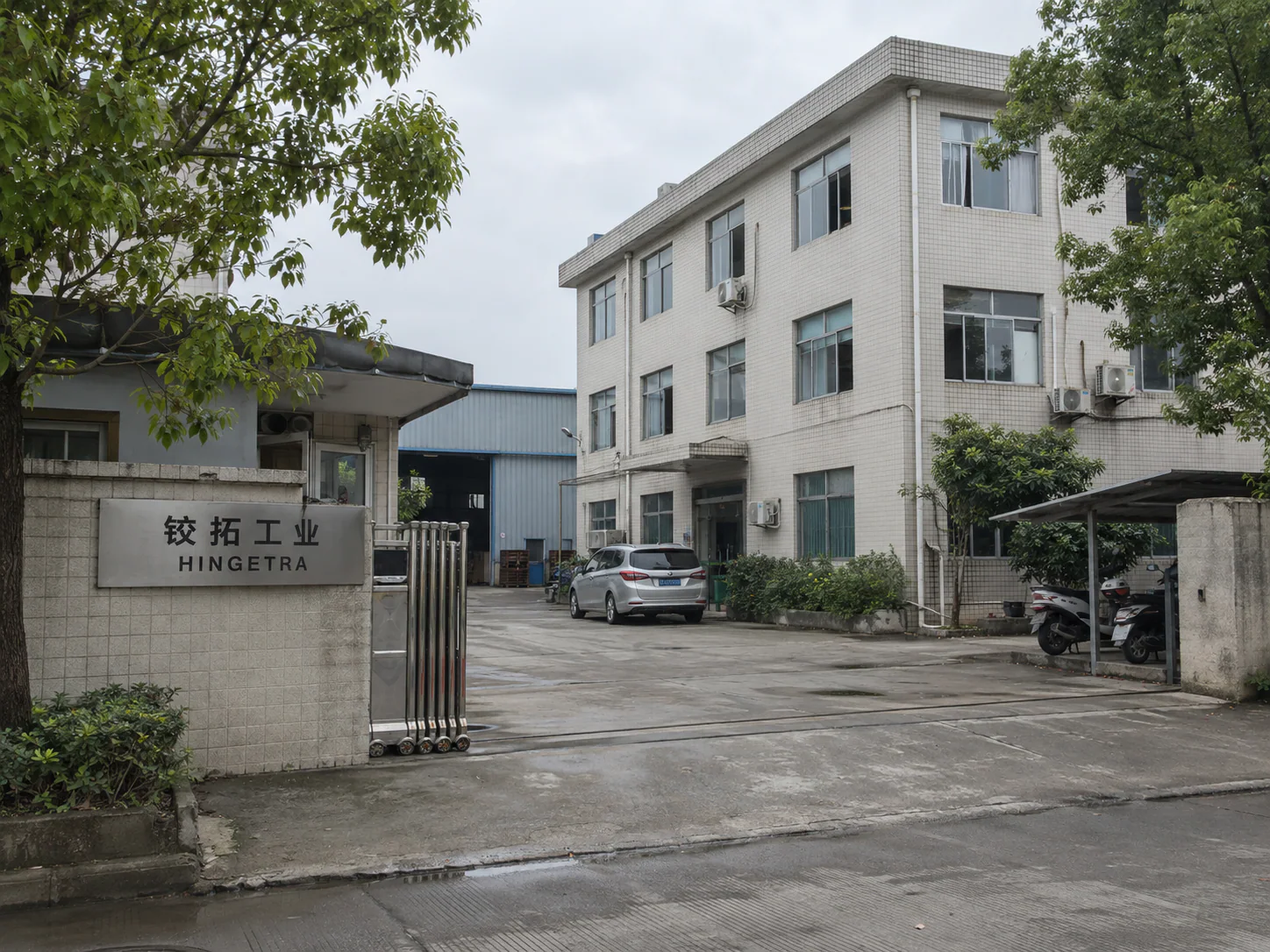 AI-generated factory exterior concept with an entrance sign reading 铰拓工业 and HINGETRA